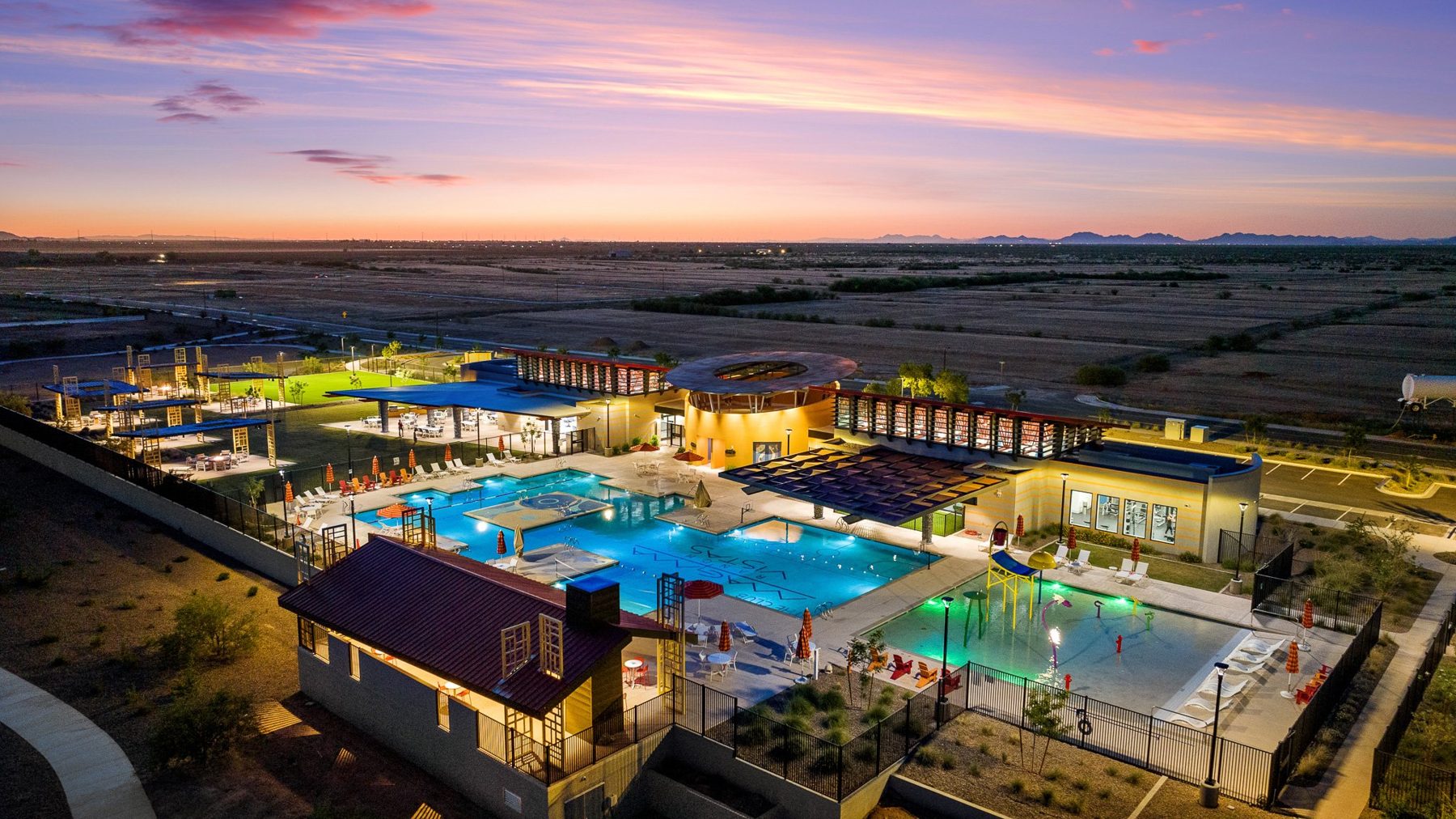 Lit pools at twilight from the air, desert all around